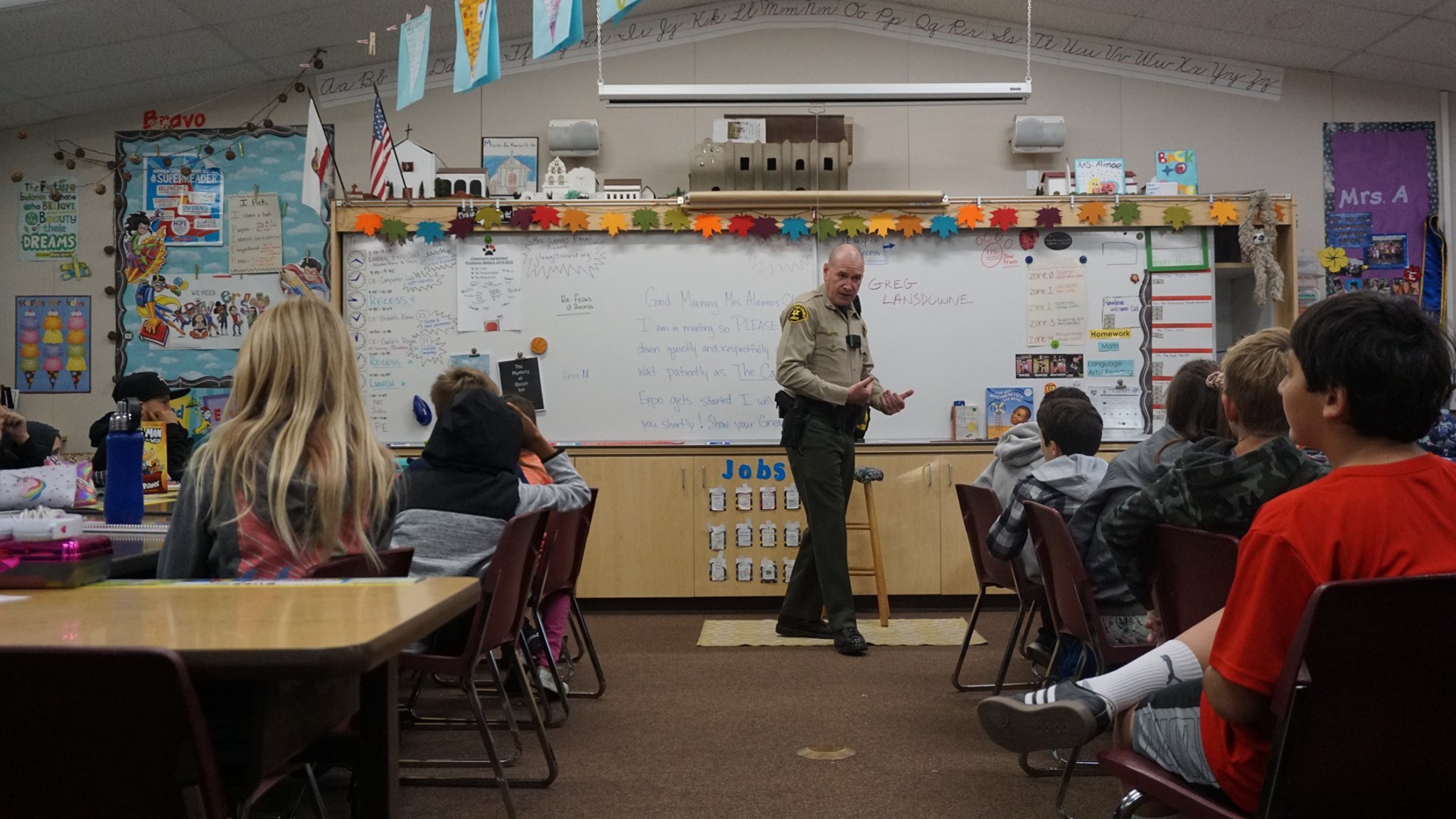 Officer talking to students in classroom