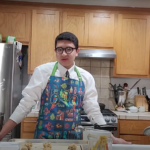 Eli Deniz in apron in kitchen
